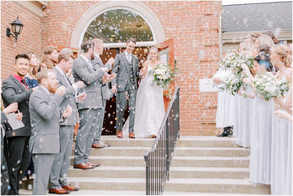 wedding recessional outside of the church with bubbles