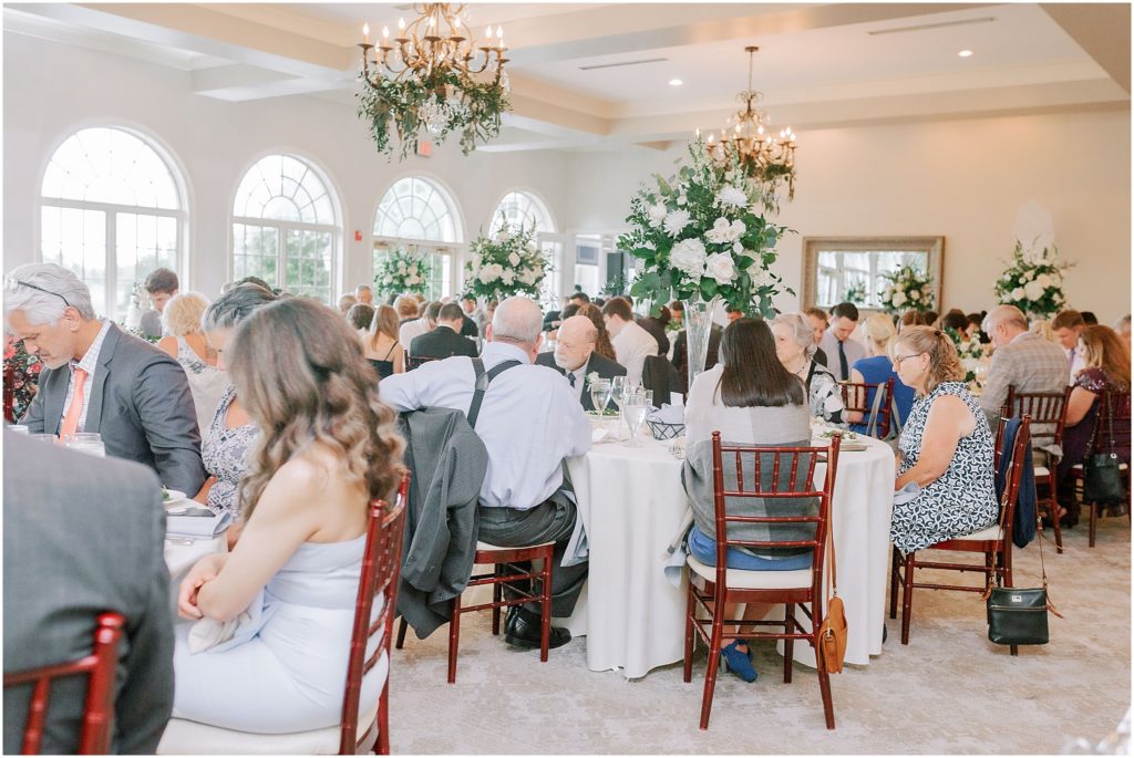 guests seated at round tables at Stonewall Golf Club indoor reception