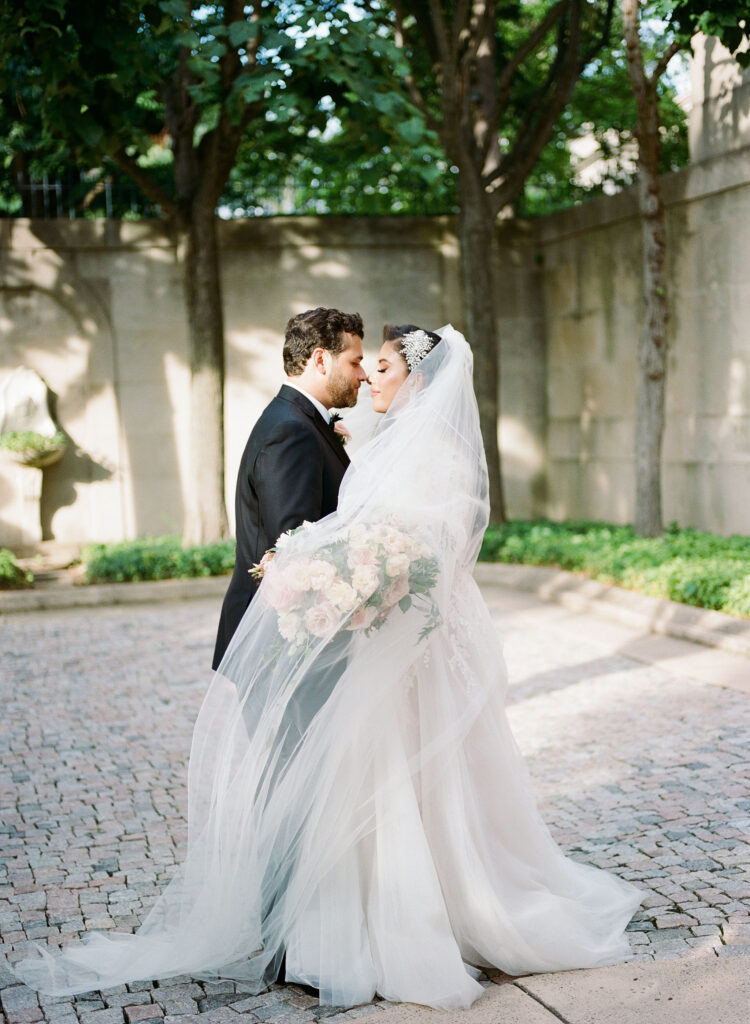 Bride and groom in embrace on the Meridian House courtyard