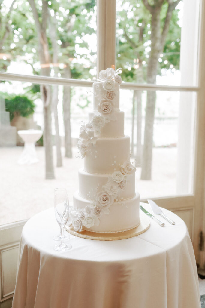 5 tiered white wedding cake adorned with white flowers