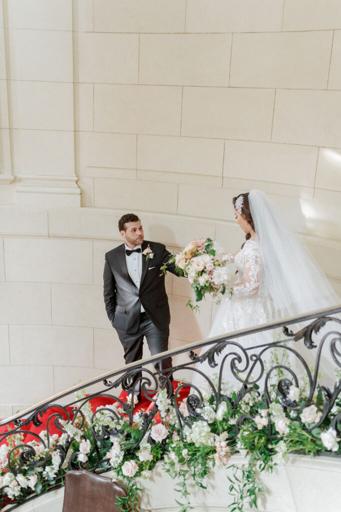 Bride and groom walking down the staircase at Meridian House