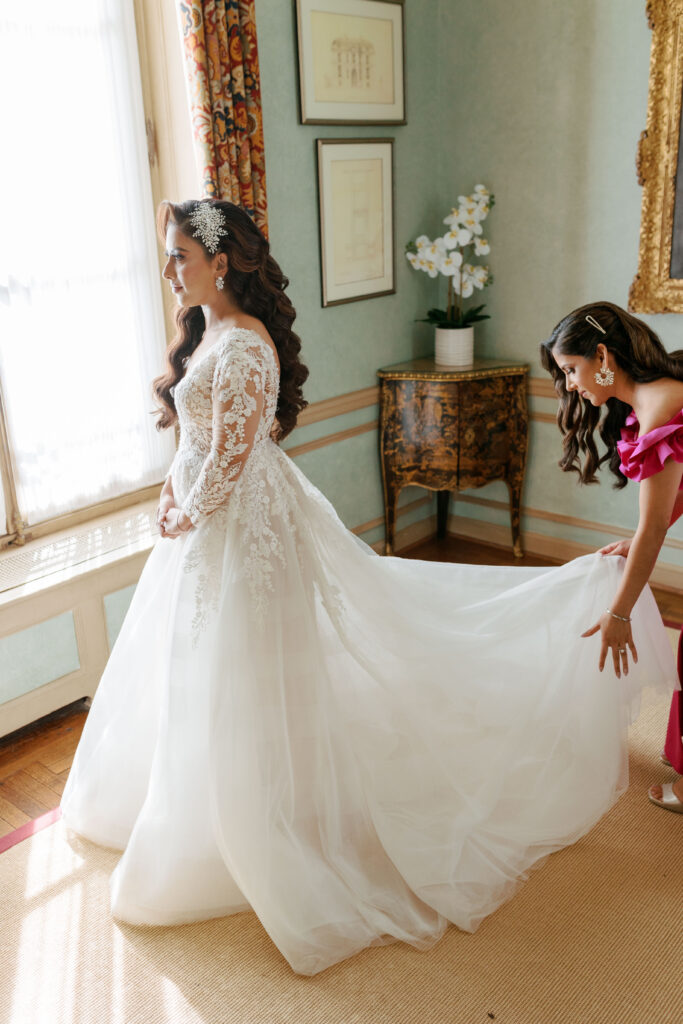 Maid of Honor adjusting the bride's wedding gown train at Meridian House